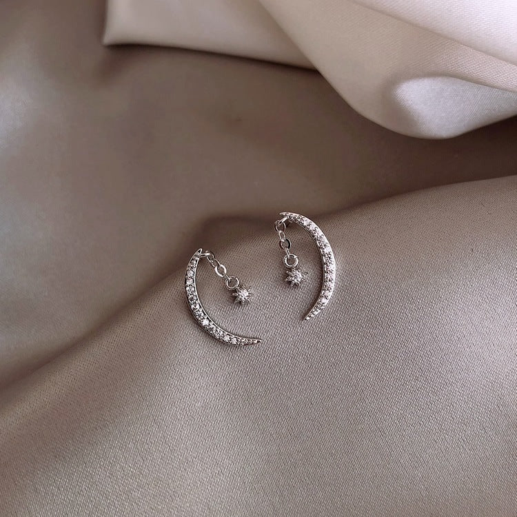 Back view displaying post and backing hardware of silver moon earrings