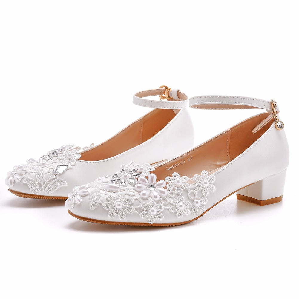 Front view of white lace bridal heel showing toe box design
