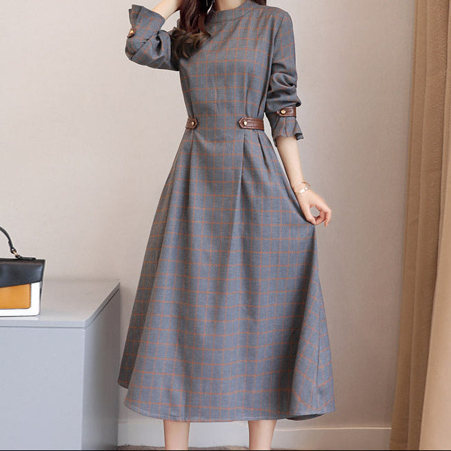 Full-length front view of black elegant dress on model, modest styling