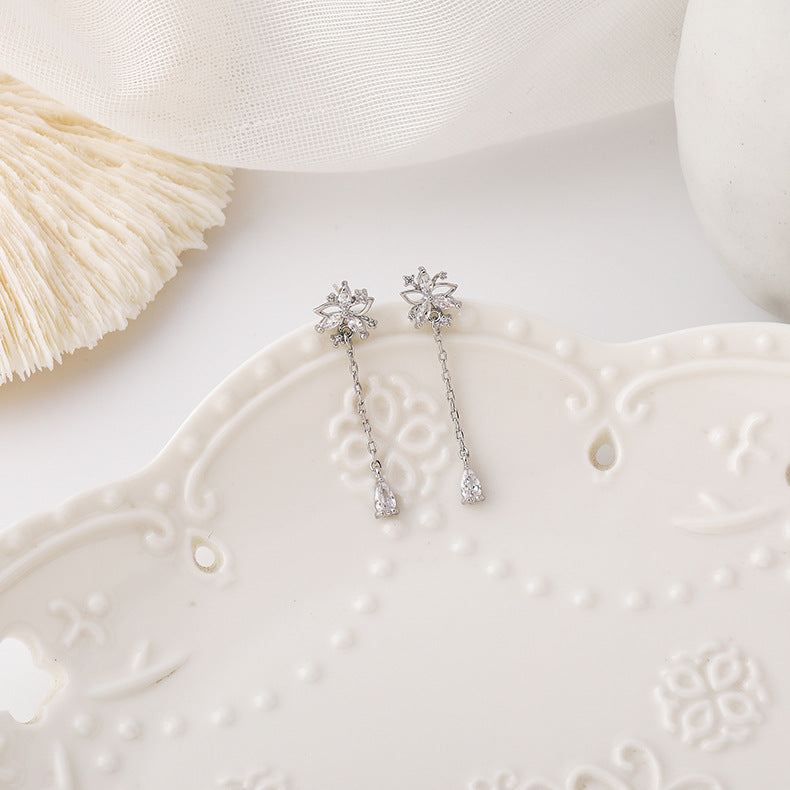 Side profile view showcasing the length and elegant drape of the hanging flower tassel earrings