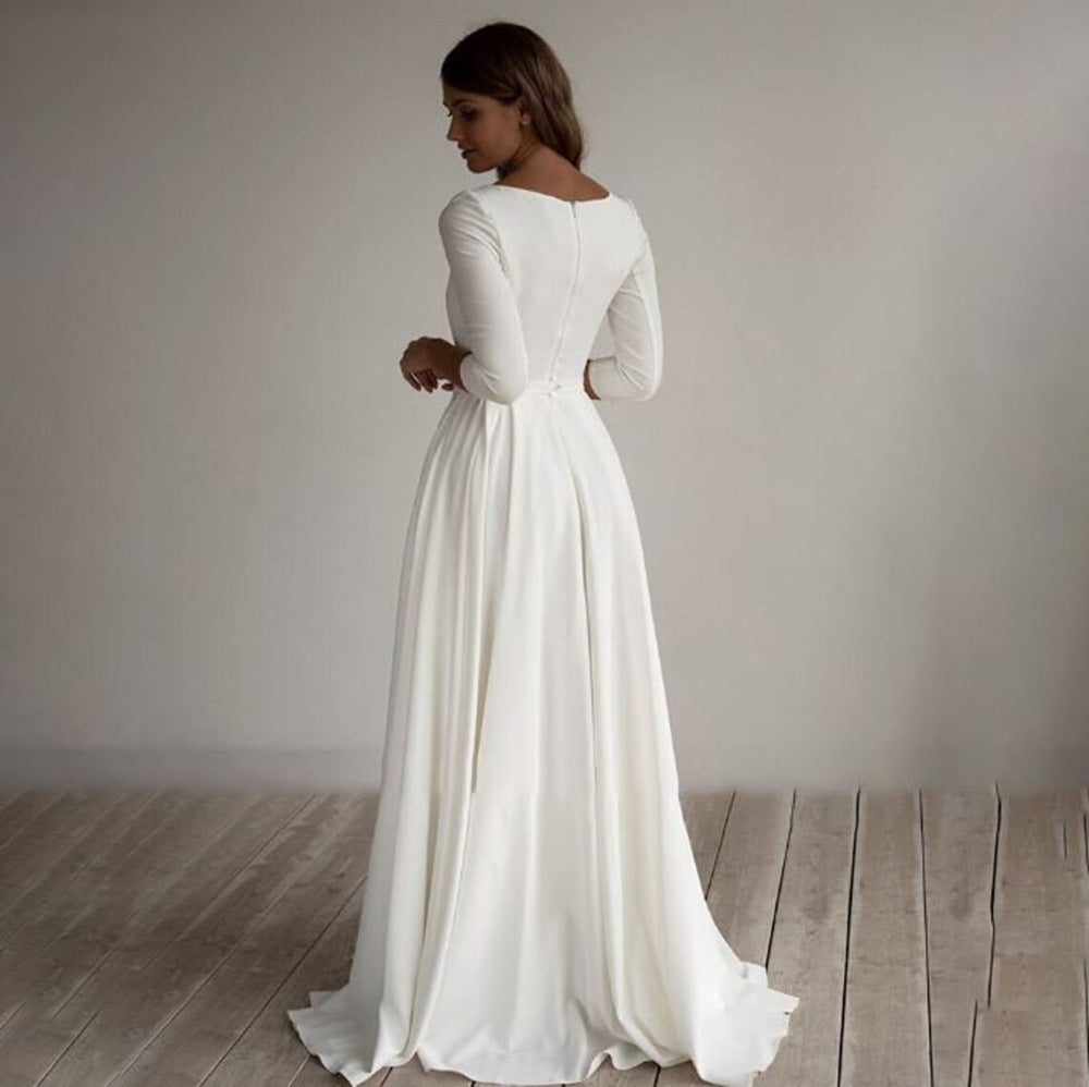 Full-length view of white modest evening dress on dress form