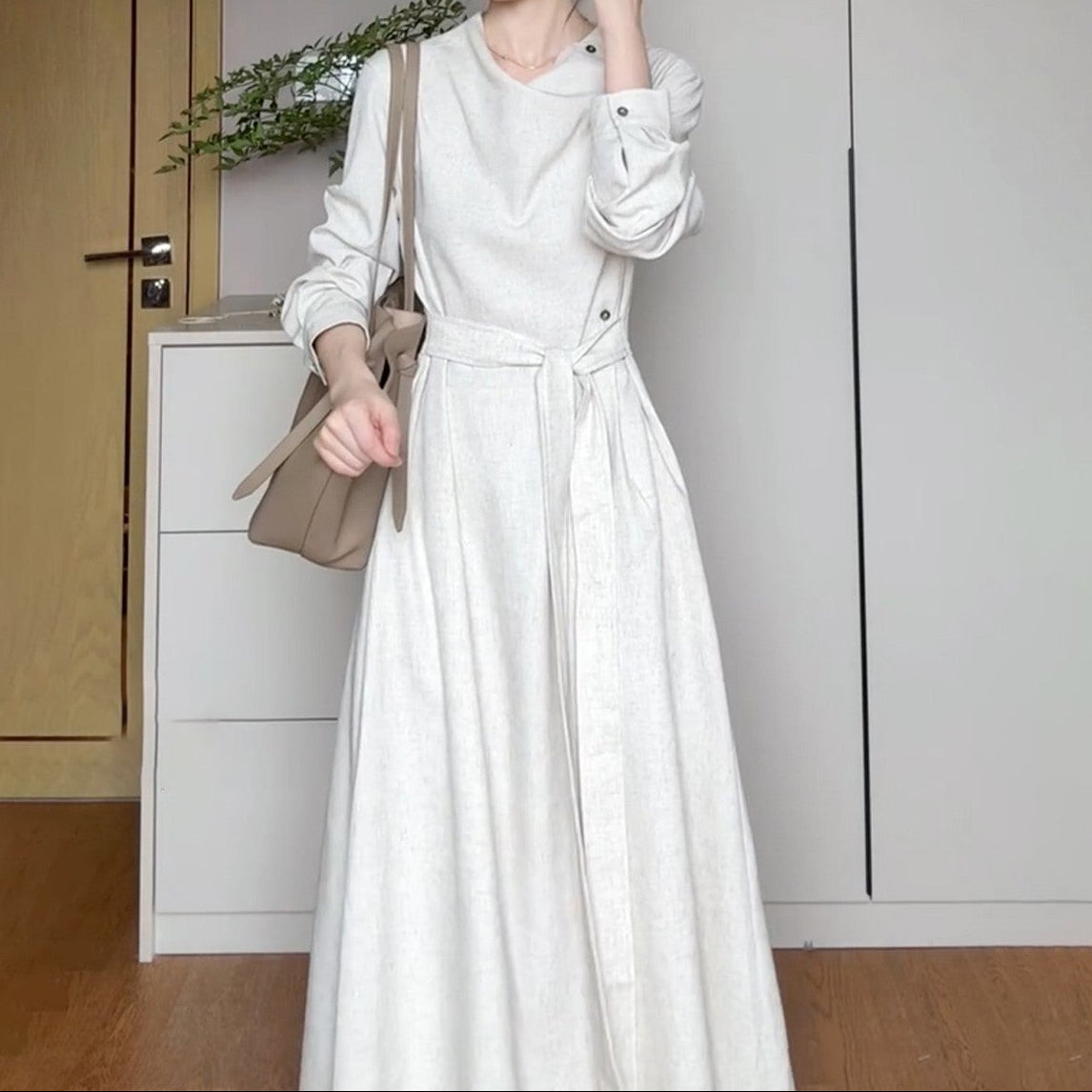 Side profile of dress highlighting fitted waist and elegant sleeve length