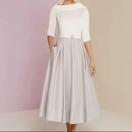 Back view of long sleeve off-shoulder dress showing elegant drape and conservative neckline design