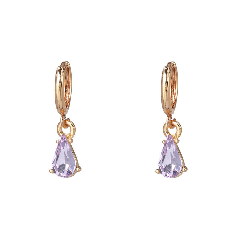 Gold glitter earrings worn on ear showing fit and style