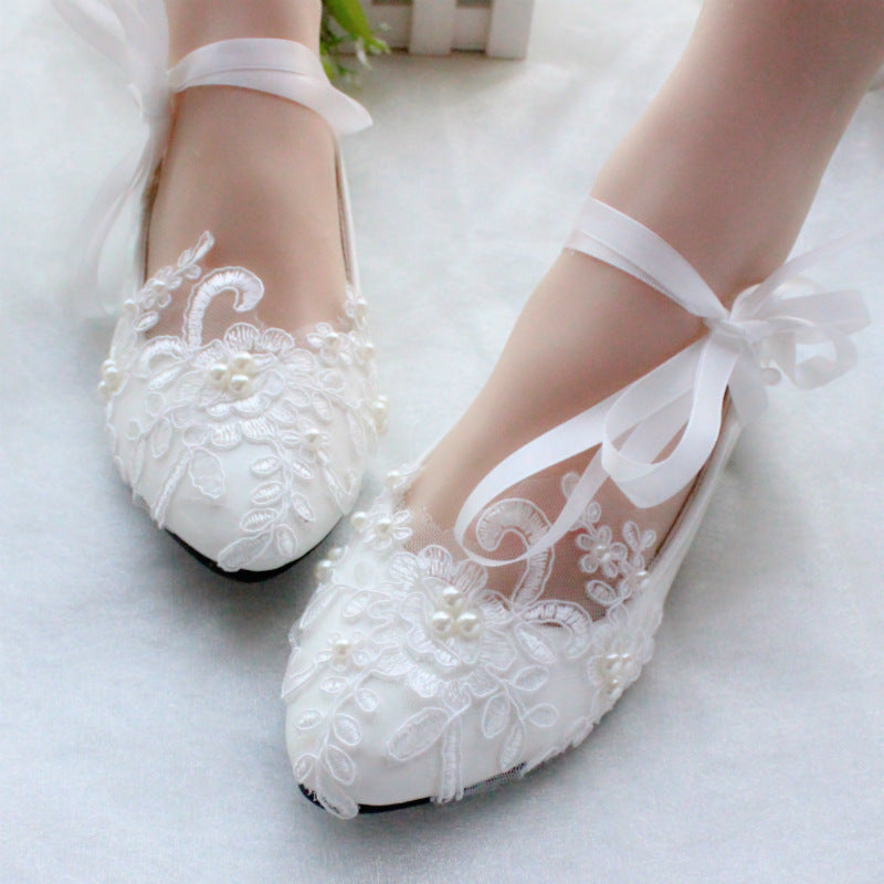 White lace bridal wedding shoes with delicate embroidered details and elegant silhouette