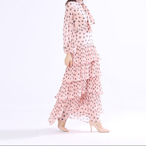 Back view of black polka dot dress showing slim silhouette and skirt length