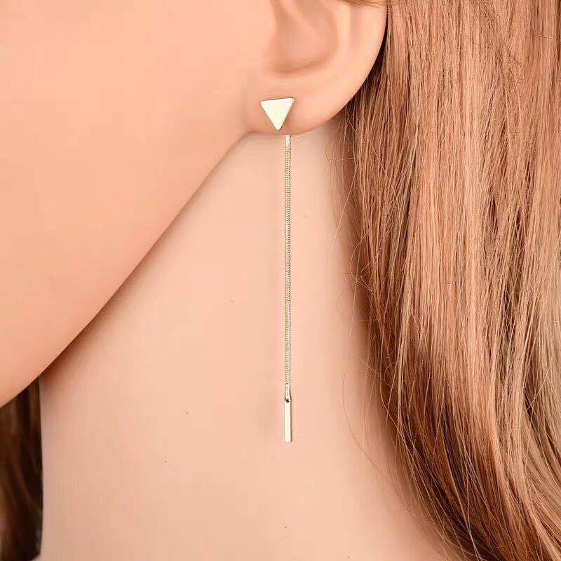 Long tassel triangle earrings in gold with delicate hanging tassels, elegant accessory