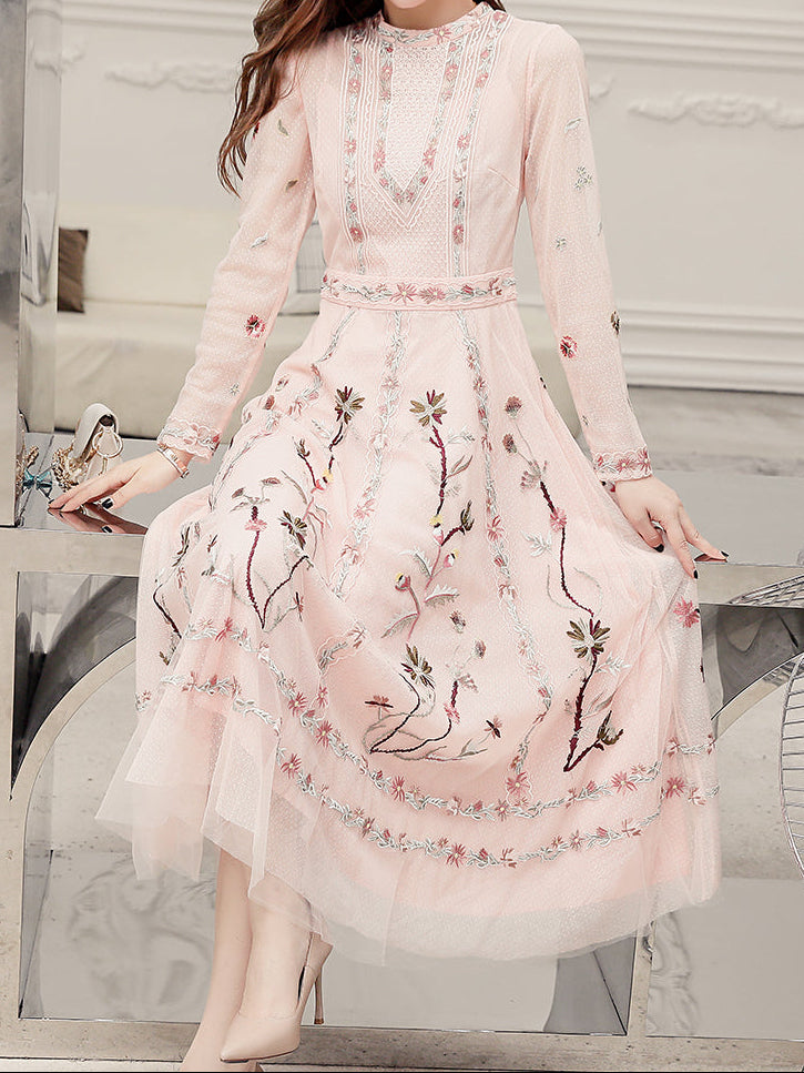 Back view of dress showing full-length silhouette and embroidered hem design