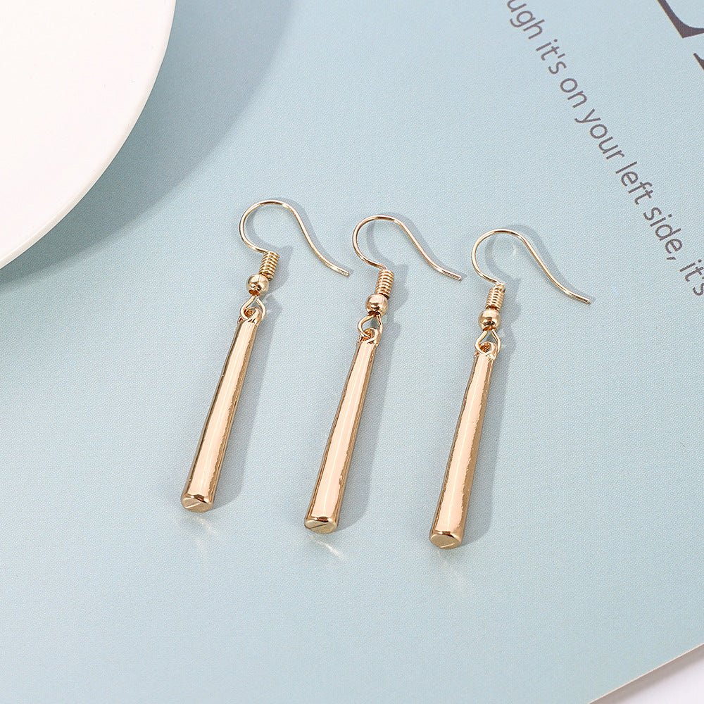 Gold long drop clip-on earrings with elegant teardrop design for modest styling