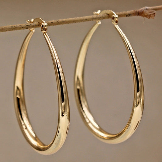 Gold geometric oval earrings with polished finish, elegant accessory for everyday wear