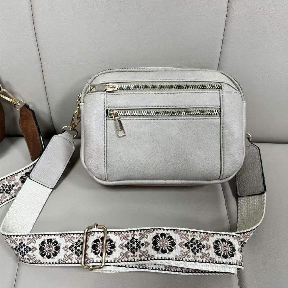 Detail of adjustable shoulder strap with hardware and attachment point