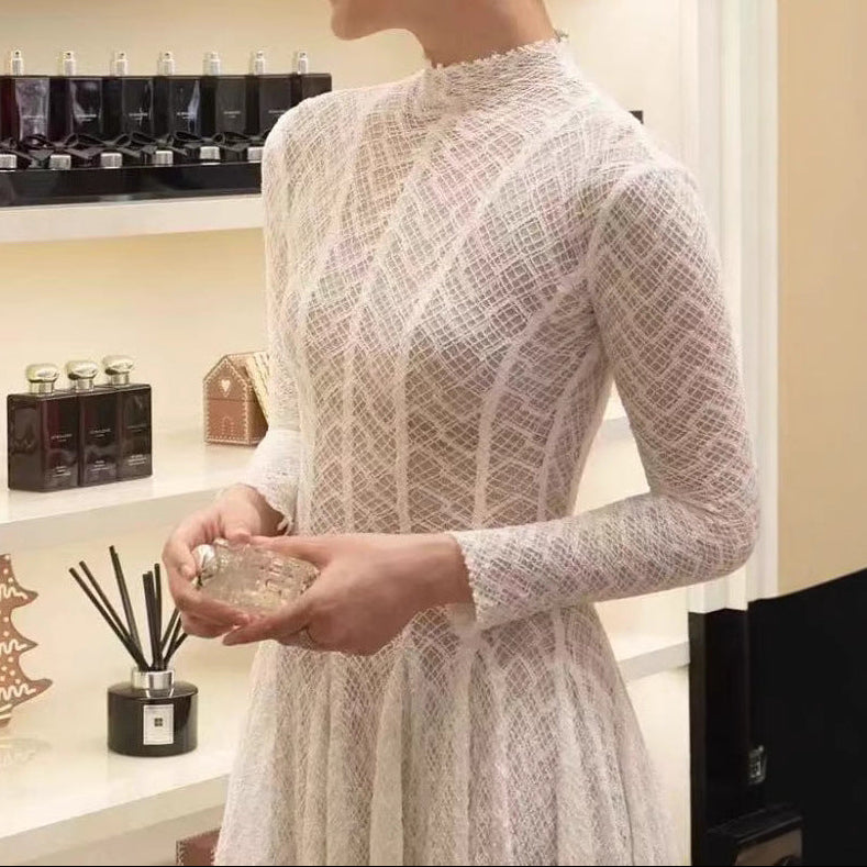 Close-up detail of delicate white lace fabric and intricate embroidery pattern