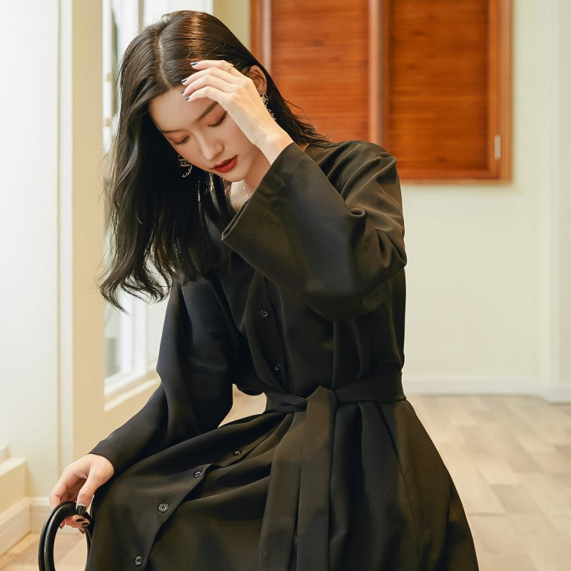 Side profile displaying fitted waist and graceful floor-length hem