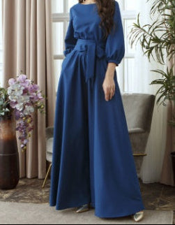 Side profile of modest maxi dress with lantern sleeves and flowing skirt