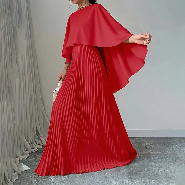 Back view of maxi dress showing pleated skirt and cape sleeve design