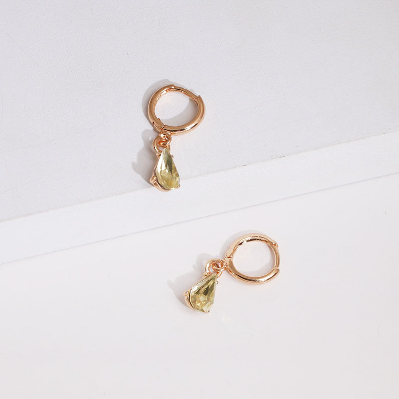Front-facing detailed view of gold glitter earring embellishment