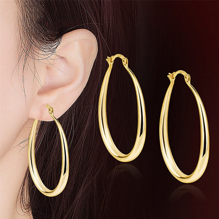 Side profile of geometric oval earring displaying depth and three-dimensional structure