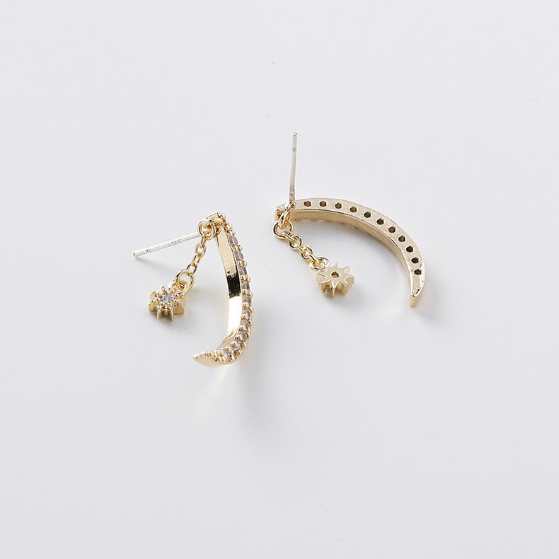 Close-up detail of sparkling cubic zirconia stones on moon-shaped earring