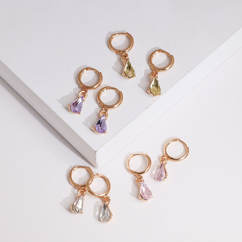 Side profile view of gold glitter earrings showing dimensional shape