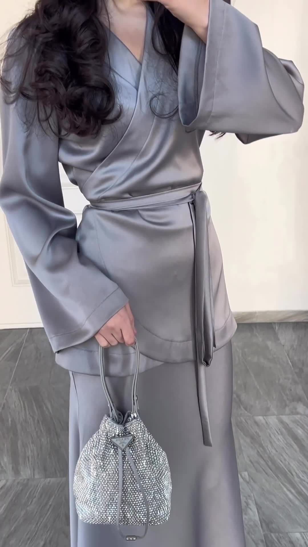 Hemline detail showing satin fabric flow at dress suit bottom