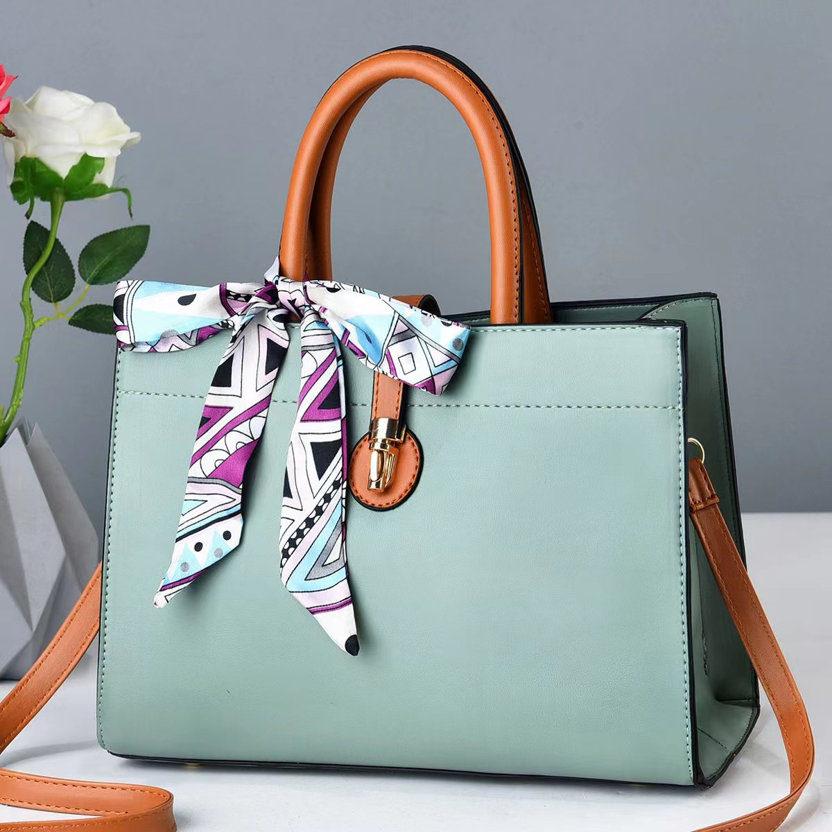 Beige designer tote bag with structured silhouette, perfect for everyday and professional occasions