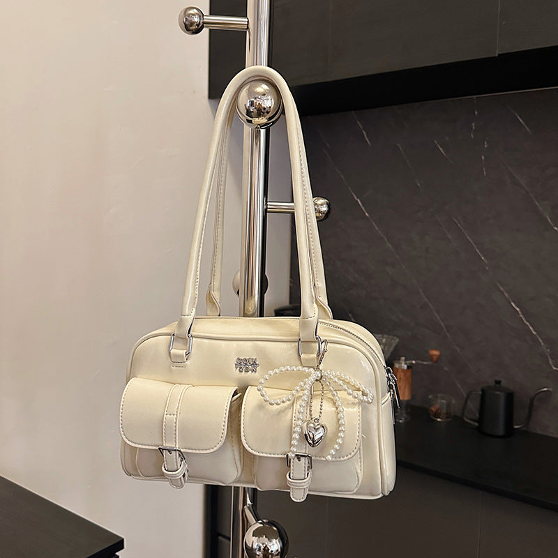 Styled flat lay of bag with complementary fashion accessories nearby