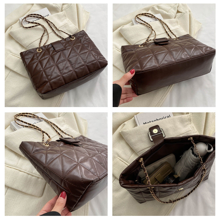 Top-down view of open black chain shoulder bag showing interior compartment