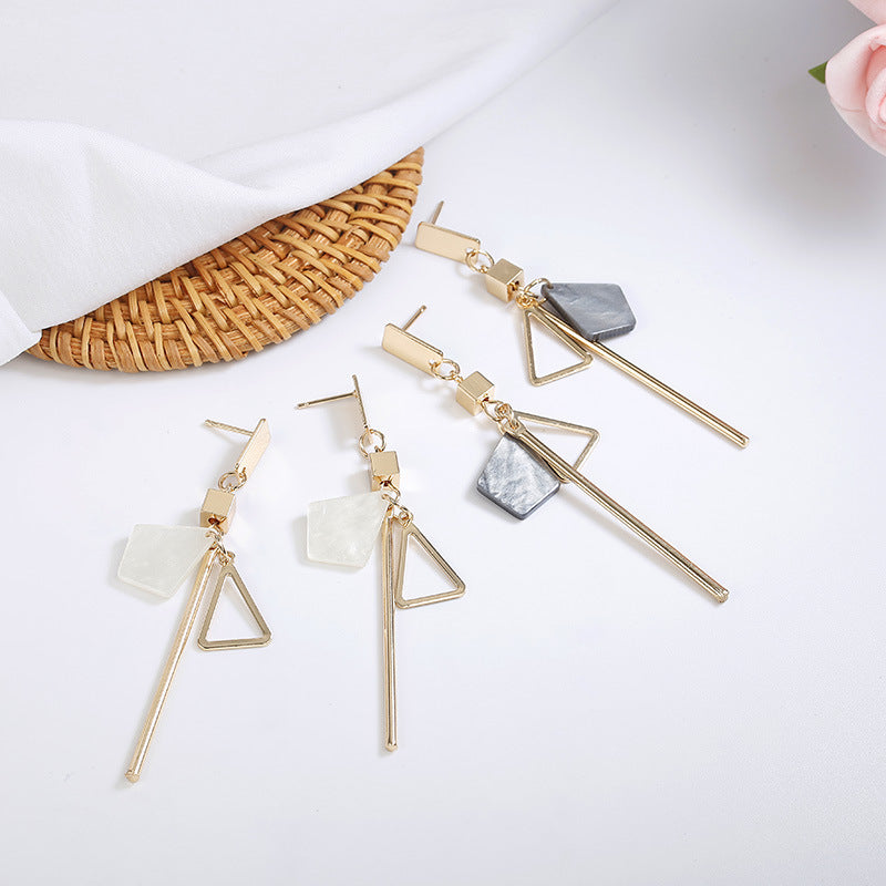 Geometric long earrings in gold and black, minimalist design for everyday wear