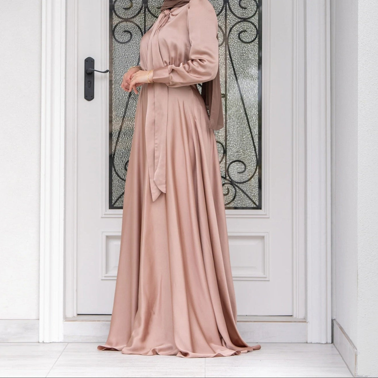 Back view of long modest dress showing elegant silhouette and full-length skirt
