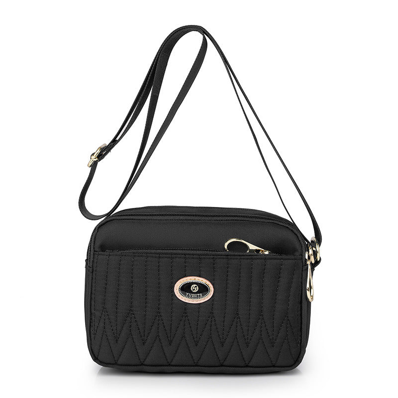 Side profile of crossbody bag displaying depth and curved shape