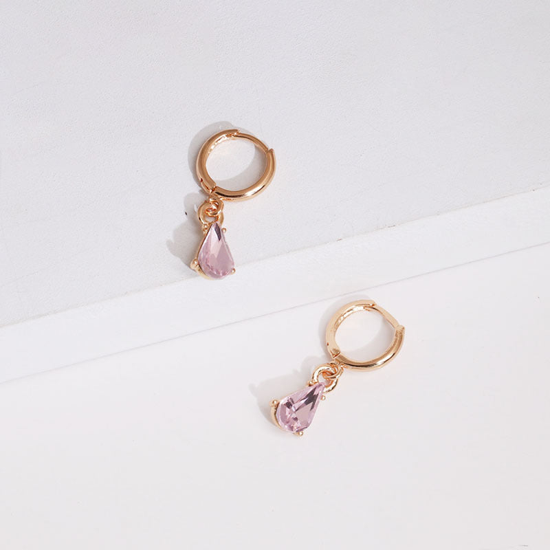 Close-up of sparkling gold glitter texture on earring surface