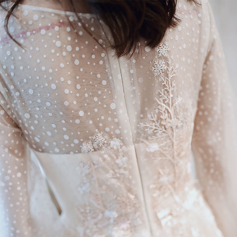 Back view showing elegant draping and modest neckline design