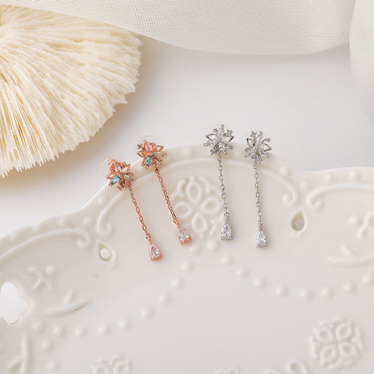 Gold flower tassel earrings with delicate petals and hanging beads, perfect for modest occasions