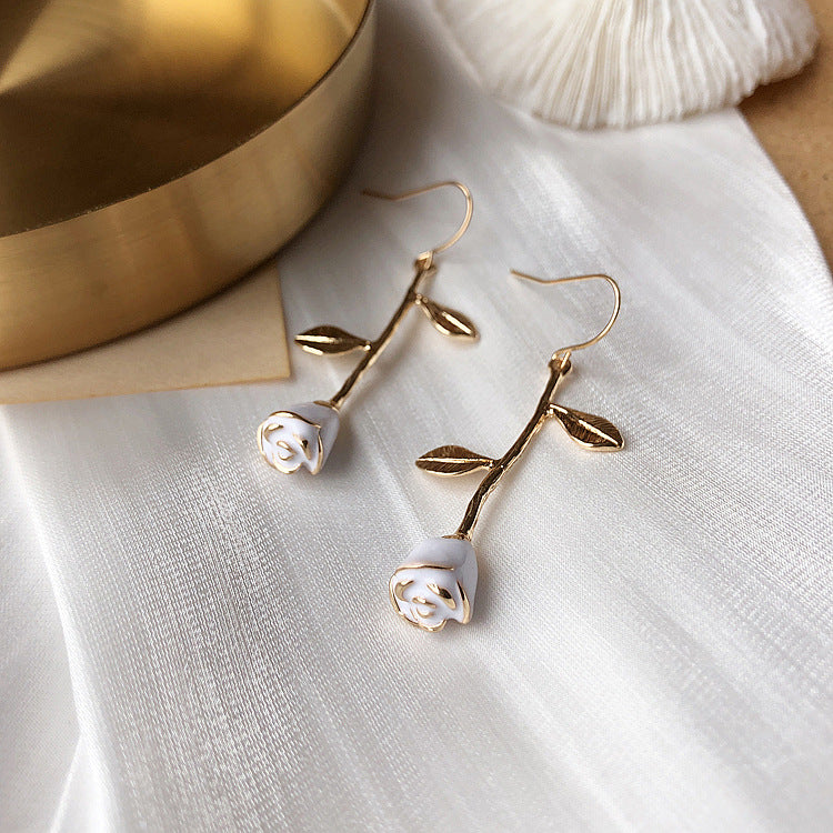 Wear view showing how floral earrings hang elegantly from earlobe