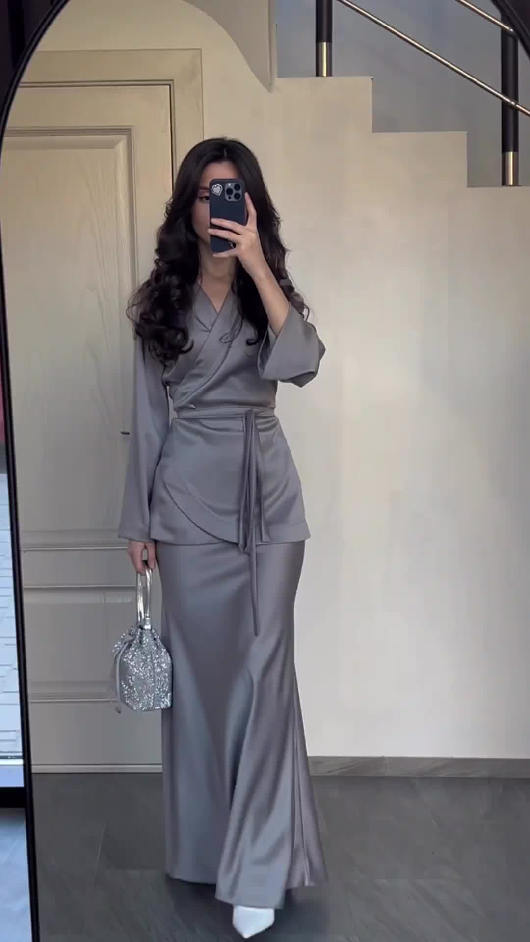 Side profile of long satin dress suit showing silhouette