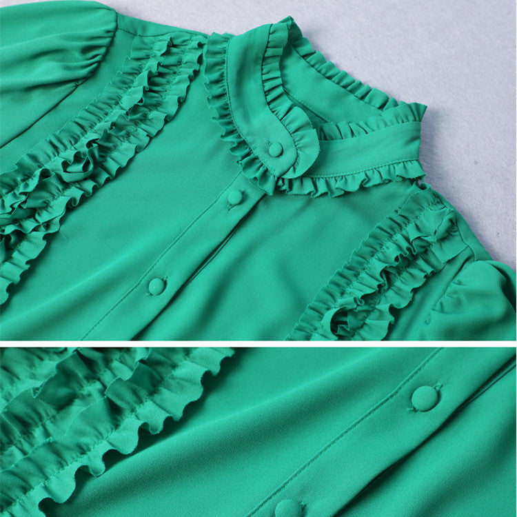 Close-up view of green dress fabric texture and long sleeve details
