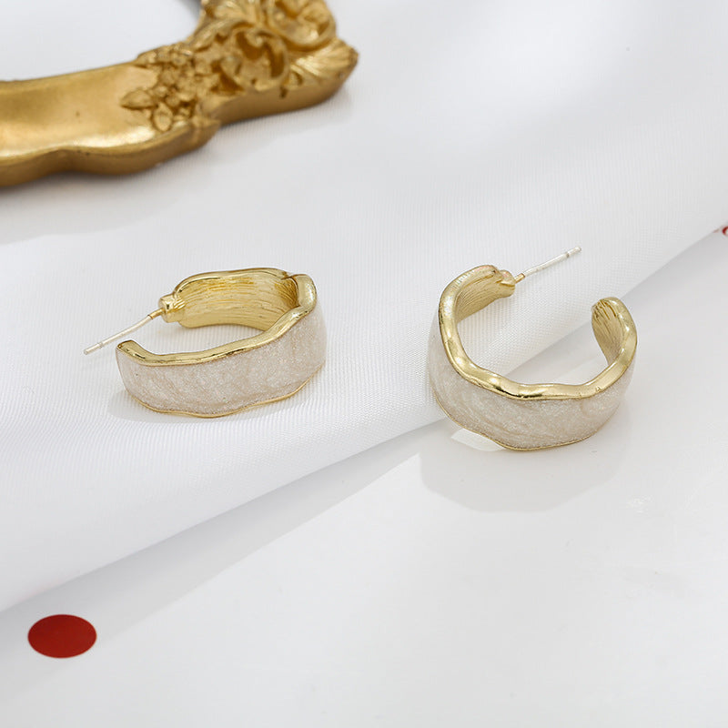 Side profile showing earring depth and dimensional floral sculptural elements