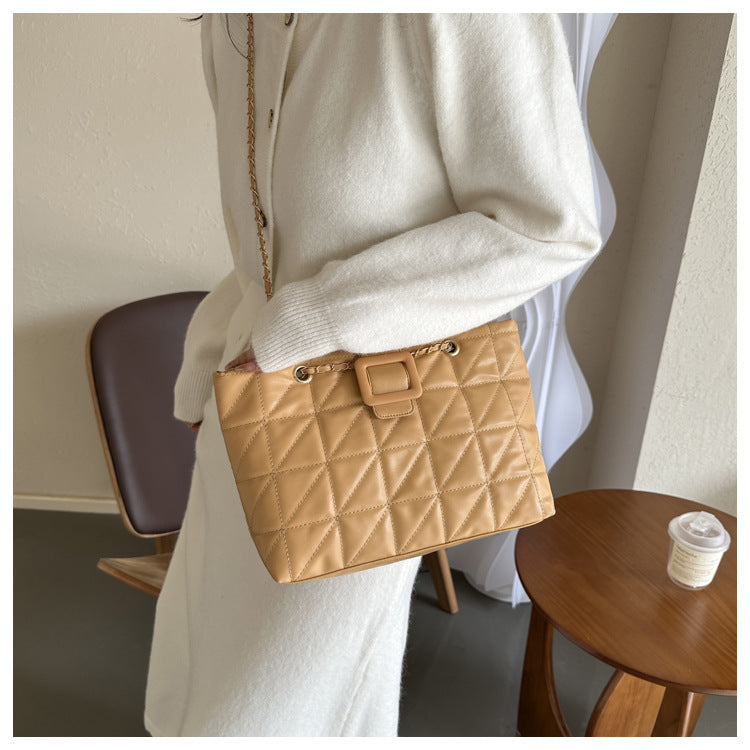 Front view of black chain shoulder bag showing quilted texture detail