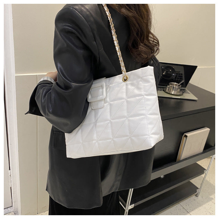 Detail of black leather exterior with quilted diamond pattern design
