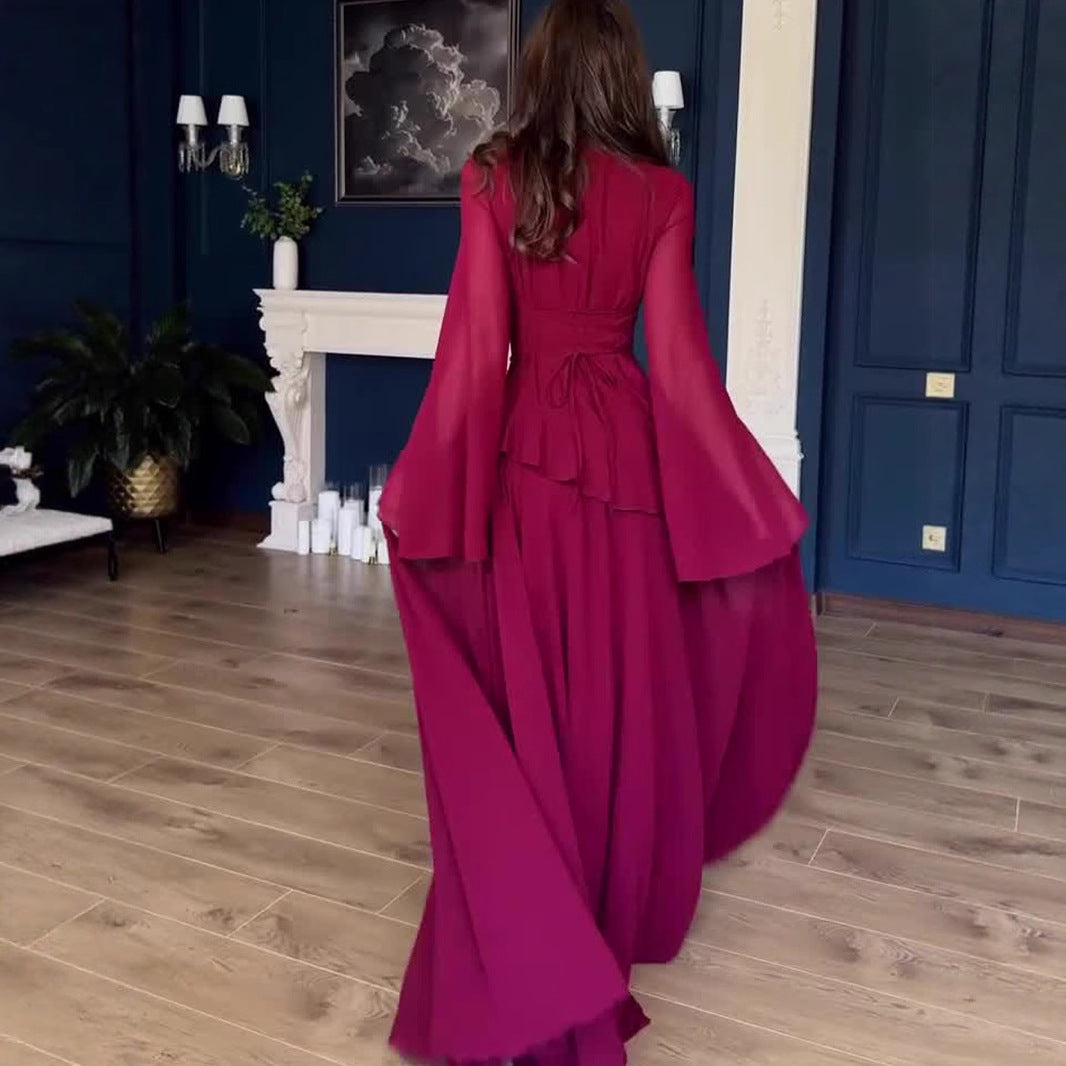 Back view showing elegant draping and long sleeve design of the dress