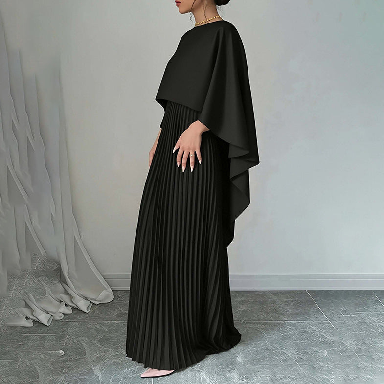 Close-up detail of cape sleeve draping and pleated fabric texture