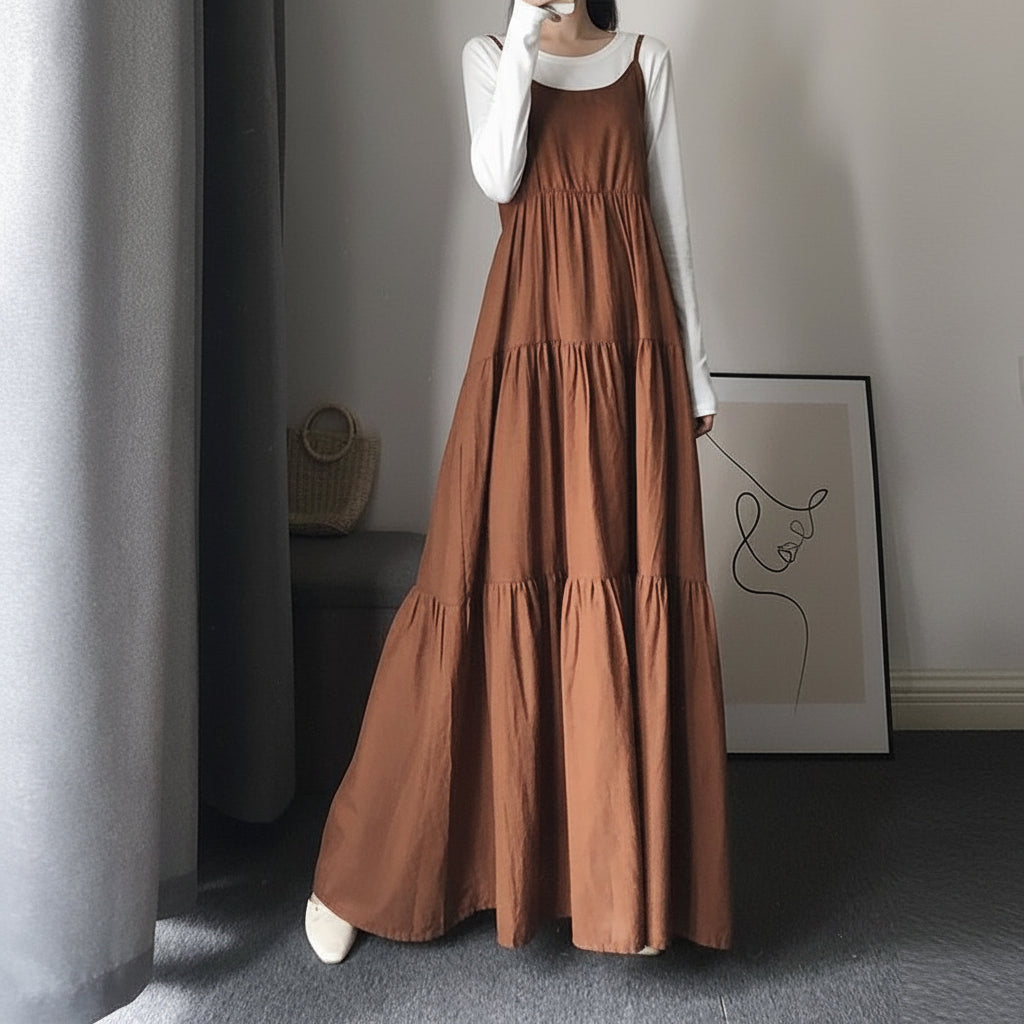 Back view of black maxi slip dress showing draped silhouette and hem detail