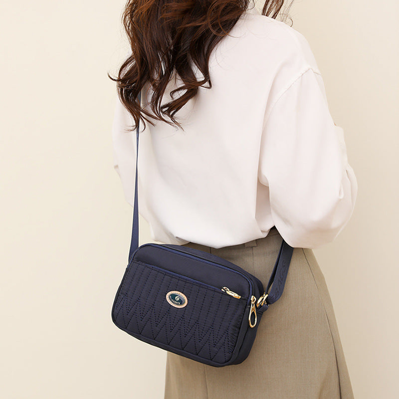 Close-up of adjustable shoulder strap with chain and leather detailing