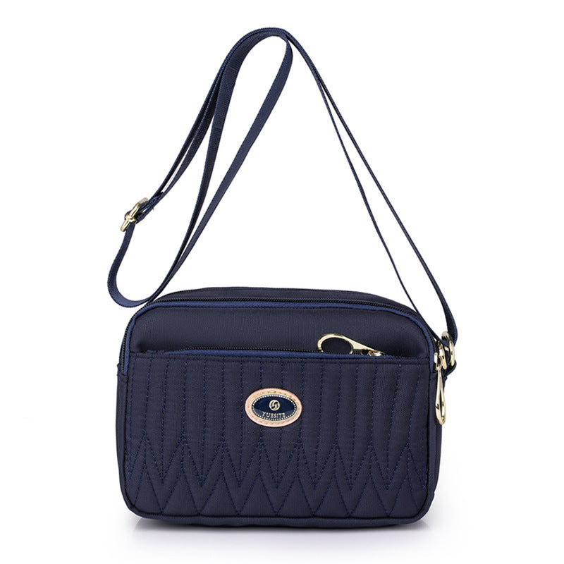 Back view of black crossbody bag with hidden pocket and strap attachment